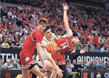  ?? MATT KROHN / USA TODAY SPORTS ?? Wisconsin forwards Carter Gilmore (14) and Chris Hodges battle for the ball against Purdue center Zach Edey on Saturday during a Big Ten Tournament semifinal in Minneapoli­s.