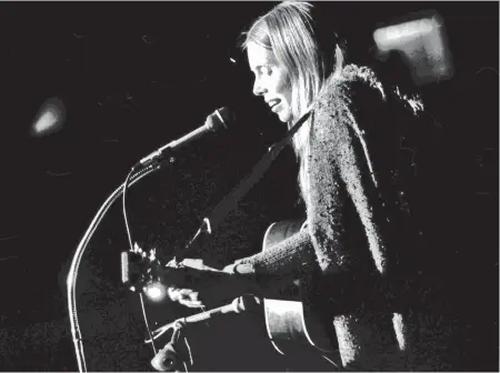  ?? GEORGE DIACK/ FILES ?? Canadian folksinger Joni Mitchell performs at a benefit concert for Greenpeace, Oct. 16, 1970. Ten thousand people attended the show at the Pacific Coliseum, which raised enough money to send a ship to protest a nuclear test at Amchitka Island, one of the Aleutians near Alaska.