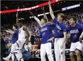 ?? Charlie Riedel ?? The Associated Press Kansas players celebrate Saturday during the second half of the team’s Big 12 conference tournament win over West Virginia in Kansas City, Mo.