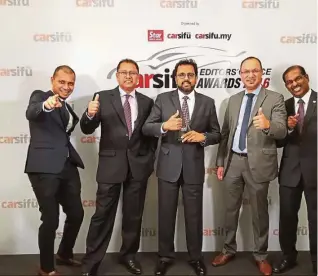  ??  ?? Naza Corp Holdings group chief operating officer (automotive group) Datuk SamSamson Anand George (centre) with Nasim (Peugeot) and Naza Euro Motors (Citroen) managemage­ment team. .