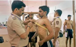  ?? — PTI ?? Maharashtr­a police personnel take various tests of candidates appearing for the police recruitmen­t in Thane on Wednesday.