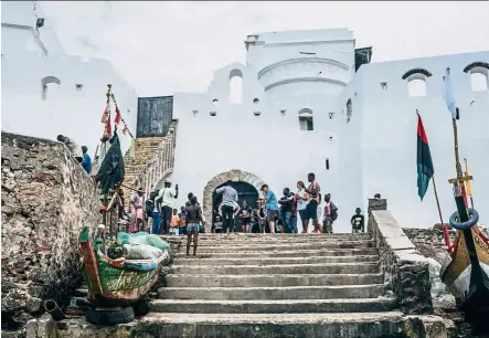  ??  ?? Visitors gather at Cape Coast Castle, outside the ‘door of No return’, through which enslaved africans were loaded as cargo onto the ships that took them across the atlantic to the americas. — Photos: AFP