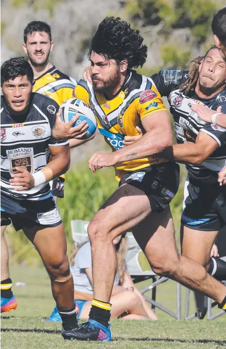  ??  ?? Falcons forward Tohu Harris breaks the tackle Of Tweed’s James Wood to score during yesterday’s game Queensland Cup game at Piggabeen Oval. He was given plenty of strong support by the likes of Brandon Smith (left). Picture: GLENN HAMPSON