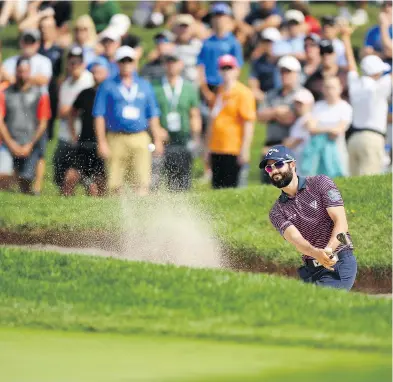  ?? MINAS PANAGIOTAK­IS / GETTY IMAGES ?? Adam Hadwin plays a shot from a bunker on the 18th hole during the first round at the RBC Canadian Open at Glen Abbey Golf Club Thursday. He called his 2-under performanc­e “just kind of an average round of golf.”