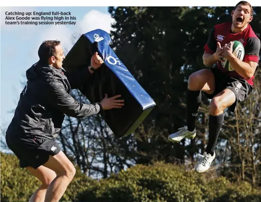  ??  ?? Catching up: England full-back Alex Goode was flying high in his team’s training session yesterday