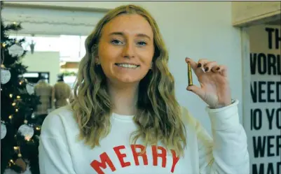  ?? Iain Woessner/Times-Record ?? ABOVE: Megan Haugrud of Blush Boutique shows off a shell casing, part of a promotiona­l drawing being held Friday/Saturday. BELOW: Snacks aplenty sweetened many deals in Valley City’s downtown.