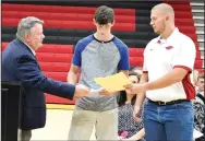  ??  ?? Pea Ridge High School 2018 valedictor­ian Zackery Humphries (right) and salutatori­an Kobe Rose (middle) received numerous scholarshi­ps and awards during the Scholarshi­p Awards presentati­on Thursday evening in the gym at PRHS.