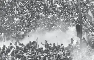  ?? Reuters-Yonhap ?? Demonstrat­ors clash with police officers during a protest against Ecuador’s President Lenin Moreno’s austerity measures in Quito, Ecuador, Tuesday.