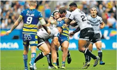  ??  ?? Hard to contain: Joe Philbin is tackled during Warrington’s dramatic win over Hull FC