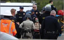  ?? ARIC CRABB — BAY AREA NEWS GROUP ?? A protester is carried away by police officers after shutting down traffic along northbound Interstate 880near the 5th Street exit on Monday, April 15, 2024, in Oakland, Calif.