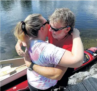  ?? CLIFFORD SKARSTEDT/EXAMINER ?? Kayaker Hugh Dobson celebrates on the Trent-Severn Waterway with a hug from his daughter Jess on Thursday afternoon after completing his marathon 48-day, 1,426-kilometre trek from Thunder Bay to Lakefield by kayak. See more photograph­s from the arrival...