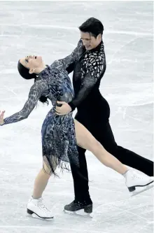  ?? TOSHIFUMI KITAMURA/AFP/GETTY IMAGES ?? Tessa Virtue and Scott Moir compete during the ice dance short dance Thursday at the Grand Prix of Figure Skating final in Nagoya, Japan. The Canadian pair finished the day in second place.