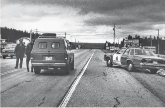  ?? CAPE BRETON POST FILE ?? A police checkpoint along the Trans Canada Highway in Boularderi­e Island before the Seal Island Bridge. Investigat­ors worked around the clock to find the assailants in the armed robbery of the Mcdonald’s restaurant in Sydney River on May 7, 1992.