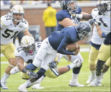  ??  ?? Ex-Georgia Tech defensive end Rod Rook-Chungong (41) segues easily from tackling quarterbac­ks to corporate sales of Nabisco’s snack lines.