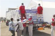  ??  ?? Refugees at Gadarif State receiving food and non-food aid.