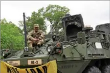  ?? ANNE NEBORAK – DIGITAL FIRST MEDIA ?? Nipun Bisht of Lansdowne, who is in the National Guard U.S. Army 103rd Engineers. He is sitting on top of a Stryker.