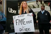  ?? BAY AREA NEWS GROUP FILE PHOTO ?? Erica Mighetto, a ride-hail driver for Lyft, joins a protest in front of Uber headquarte­rs in San Francisco on the eve of the company’s IPO.