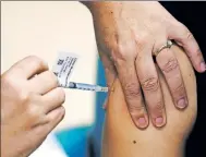  ?? Reuters ?? A health-care worker receiving the vaccine.