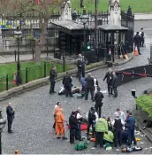  ?? — AP ?? Emergency services attend to the injured outside the Palace of Westminste­r in London on Wednesday.
Following the attack, Britain is on its second-highest alert level of ‘severe’. This means an attack by militants is considered highly likely, officials...