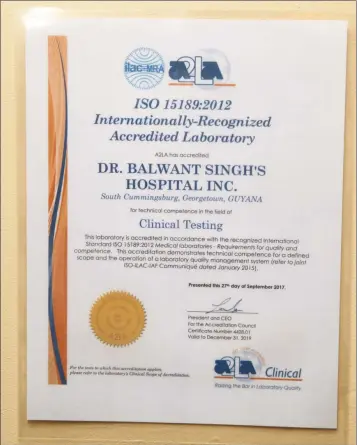  ?? (Keno George photo) ?? The ISO 15189:2012 certificat­e of accreditat­ion which was presented to the Dr. Balwant Singh’s Hospital Inc.