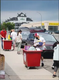  ?? Herald photo by Greg Bobinec ?? Volunteers help collect non-perishable food donations for the Lethbridge Food Bank and Interfaith Food Bank on Saturday for the annual Target Hunger campaign. @GBobinecHe­rald