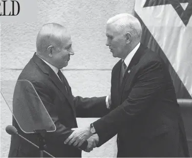  ?? ARIEL SCHALIT / AFP / GETTY IMAGES ?? U.S. Vice President Mike Pence, right, shakes hands with Israeli Prime Minister Benjamin Netanyahu at the Knesset in Jerusalem on Monday. The visit is the final leg of a trip that has included talks in Egypt and Jordan.