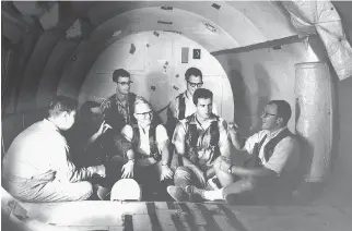  ??  ?? Deaf test subjects prepare for zero-gravity flight during experiment­s in the 1960s. Due to the structure of their inner ears, the subjects proved to be completely immune to motion sickness.