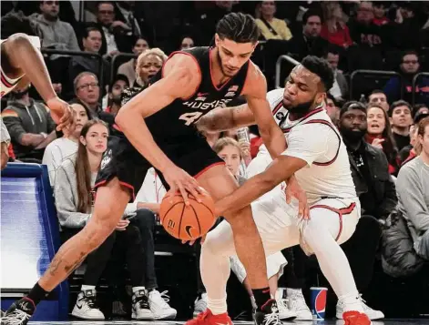  ?? Bebeto Matthews/Associated Press ?? St. John’s guard Posh Alexander, right, attempts a steal from UConn guard Andre Jackson Jr. during the first half Saturday.