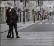  ??  ?? A couple takes a selfie on a quiet New Bond Street in London on Saturday.