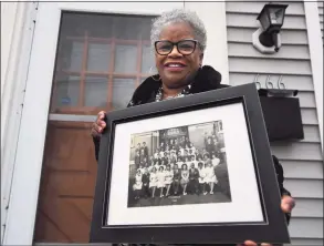  ?? Brian A. Pounds / Hearst Connecticu­t Media ?? State Sen. Marilyn Moore holds the photo of her 8th grade 1962 graduating class from Columbus School in Bridgeport on Thursday. At Columbus, Moore met teacher and civil rights activist Charles Tisdale, who introduced her to the movement.