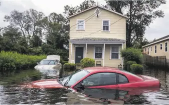  ?? Victor J. Blue / New York Times 2108 ?? A neighborho­od in New Bern, N.C., is flooded by Hurricane Florence in 2018. Real estate markets are already feeling the effects of climate change, researcher­s say.