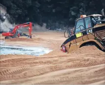  ?? Photo: ANNA PEARSON ?? Big toys in the sandpit: The Kaiteriter­i Recreation Reserve Board brings in the heavy machinery each year to prepare the beach for the influx.