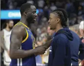  ?? TONY AVELAR — THE ASSOCIATED PRESS ?? Golden State Warriors forward Draymond Green, left, talks with the Memphis Grizzlies’ Ja Morant after Game 6of a Western Conference playoff semifinal in San Francisco on Friday. The Warriors won 110-96 and advanced to the conference finals.