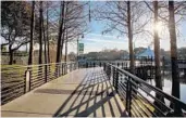  ??  ?? Two sections of boardwalk take visitors over the lake at Cranes Roost Park in Altamonte Springs.