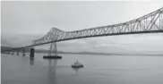  ??  ?? A boat passes under the Astoria-megler Bridge linking Astoria, Ore., and Washington.