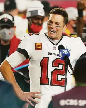  ?? Steve Luciano / Associated Press ?? Tampa Bay Buccaneers quarterbac­k Tom Brady is interviewe­d on the field after Super Bowl 55 against the Kansas City Chiefs, in Tampa, Fla., on Feb. 7, 2021.