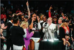  ?? FRANK FRANKLIN II / ASSOCIATED PRESS ?? Las Vegas Aces’ A’ja Wilson, center, and Mark Davis celebrate with teammates following their series-clinching win in Game 4 of the WNBA Finals on Wednesday night at the Barclays Center in New York.