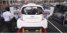  ?? PHOTO: REUTERS ?? Employees work on a Chevrolet Beat car on an assembly line at the General Motors plant in Talegaon, Maharashtr­a