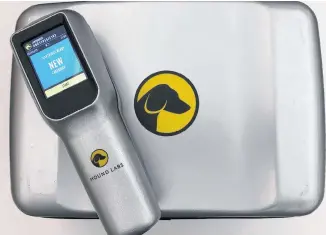  ?? JANE ROSS/REUTERS ?? A Hound Labs marijuana breathalyz­er, which the Oakland-based company says can detect minuscule amounts of THC on a user’s breath, lies on top of its base-station in Newark, Calif., earlier this month.