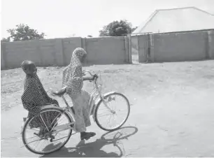  ??  ?? Two girls in Chibok town celebrate the release of the 21 schoolgirl­s