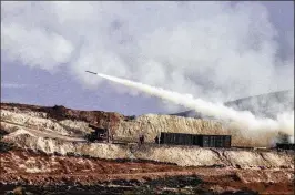  ?? ASSOCIATED PRESS ?? Turkish artillery forces in Hatay, Turkey, fire toward Syrian Kurdish positions in the Afrin area of Syria on Friday. Turkey’s military said its jets hit 19 targets, including shelters, ammunition depots and gun positions belonging to “terror”...