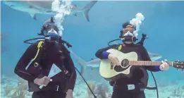  ??  ?? Comedian J.B. Smoove and Paisley perform underwater to see how sharks respond to the music.