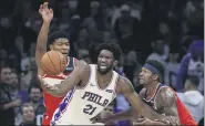  ?? MATT ROURKE — THE ASSOCIATED PRESS ?? Sixers central star Joel Embiid, center, here being defended by Washington’s Rui Hachimura, left, and Bradley Beal last fall, is allegedly healthy and ready for action as the team re-starts its season Saturday against the Indiana Pacers in a Florida bubble.