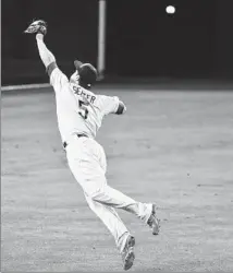  ?? Lenny Ignelzi Associated Press ?? MAKING HIS major league debut with the Dodgers, Corey Seager can’t make the catch on a ball hit by Derek Norris.