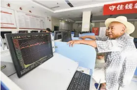  ?? AFP via Getty Images ?? An investor monitors stocks at a securities company in Fuyang in China’s eastern Anhui province. Shanghai stocks surged to a twoyear high.