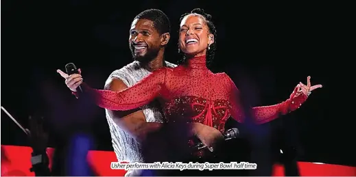  ?? ?? Usher performs with Alicia Keys during Super Bowl half time