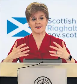  ?? Pictures: Mhairi Edwards/PA. ?? Top: Manager Rachel Garthley serving one of the last pints to Alex Galloway in the Club Bar, Dundee, yesterday. Above: First Minister Nicola Sturgeon speaking during a briefing on coronaviru­s in Edinburgh.