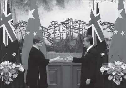  ?? Photo: AFP ?? Chinese Foreign Minister Wang Yi (right) and Australian Foreign Minister Marise Payne shake hands during a news conference at the Diaoyutai State Guesthouse in Beijing on Thursday.