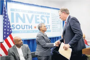  ?? ARMANDO L. SANCHEZ/CHICAGO TRIBUNE ?? Mayor Lori Lightfoot greets David Casper, president and CEO of BMO Harris Bank, during an INVEST South/West announceme­nt at L.May Creations in the Austin neighborho­od on Oct. 21, 2019 in Chicago.