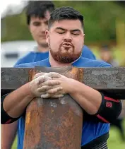  ??  ?? Jamie Dunn carries the 130kg weight in the anvil carrying event.